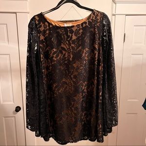 60’s style shift dress with black lace sleeved wings, nude underdress.